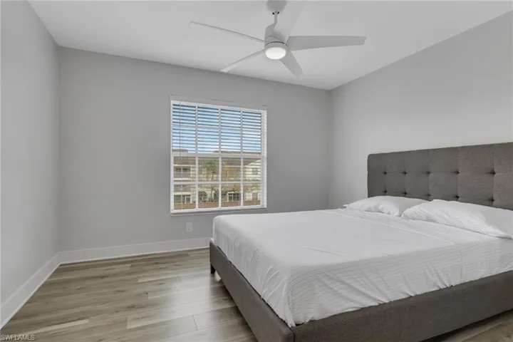 Guest bedroom featuring light wood-style floors and ceiling fan