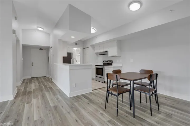 Dining room featuring light wood-style flooring and baseboards