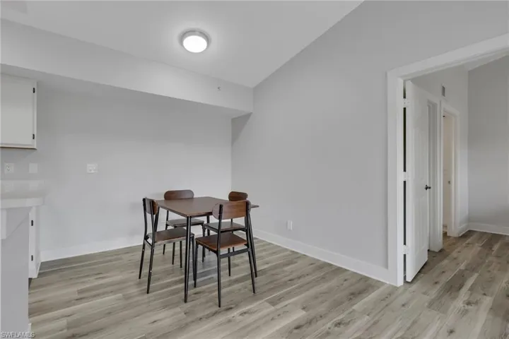 Dining area featuring lofted ceiling and light wood finished floors