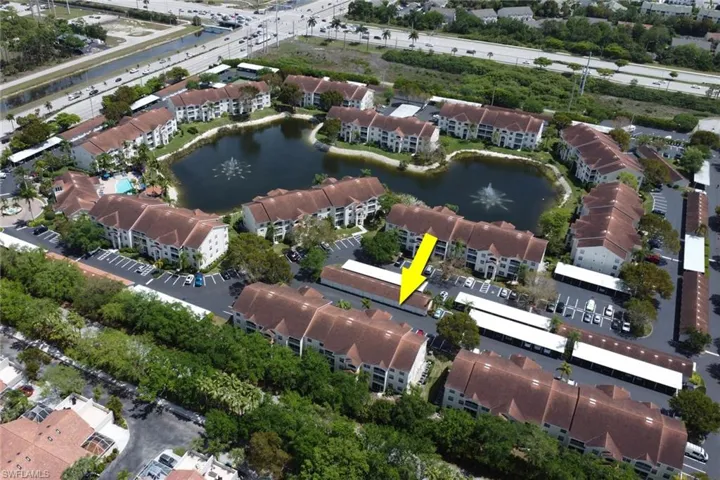 Aerial view of property's location with a nearby body of water and apartment complex / building