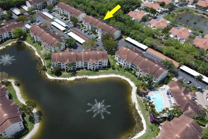 Aerial overview of property's location featuring a nearby body of water and apartment complex