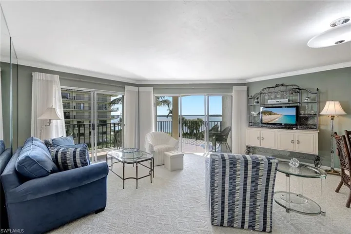 Carpeted living room with crown molding