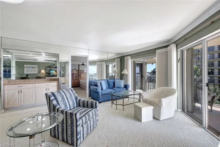 Living room featuring light colored carpet and crown molding