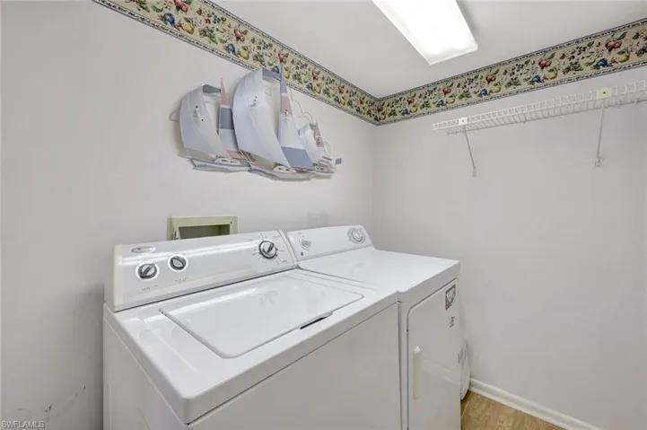 Laundry area featuring light wood-type flooring and separate washer and dryer