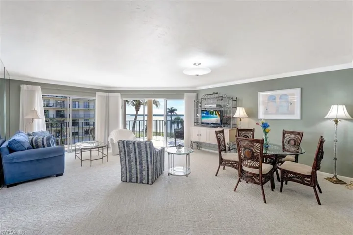 Carpeted living room featuring crown molding
