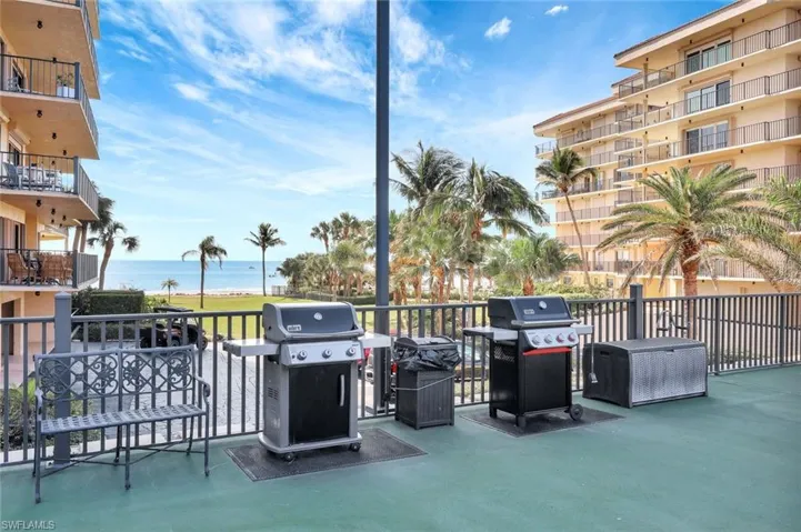 View of patio / terrace with a water view and a grill