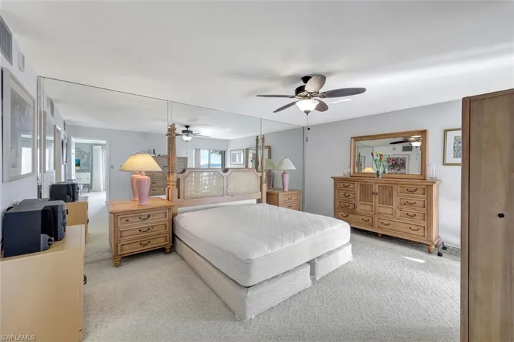 Carpeted bedroom featuring ceiling fan