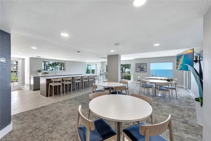 Carpeted dining area with a water view