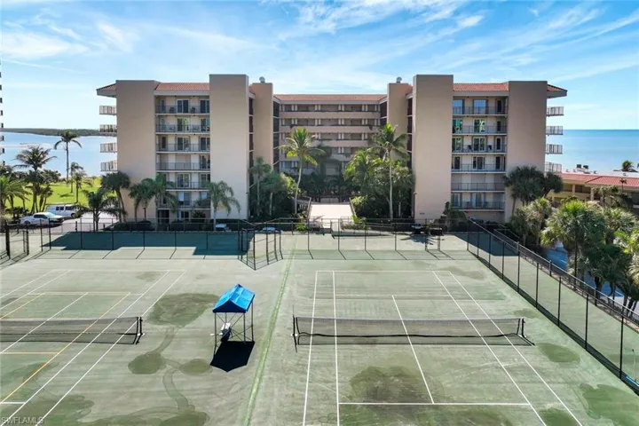 View of sport court featuring a water view
