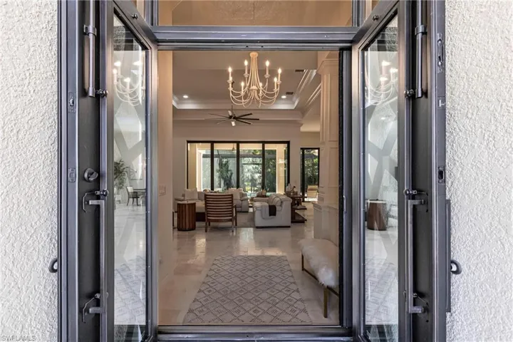 View of exterior entry featuring stucco siding and a ceiling fan
