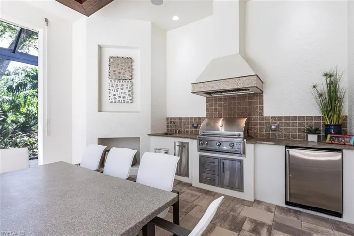 View of patio / terrace with outdoor dining space, exterior kitchen, a sink, and grilling area