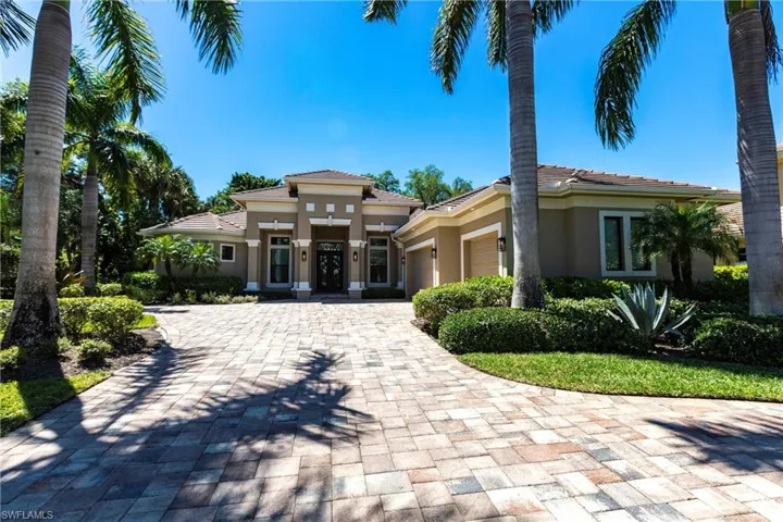 View of front of home featuring a tiled roof, decorative driveway, a garage, and stucco siding