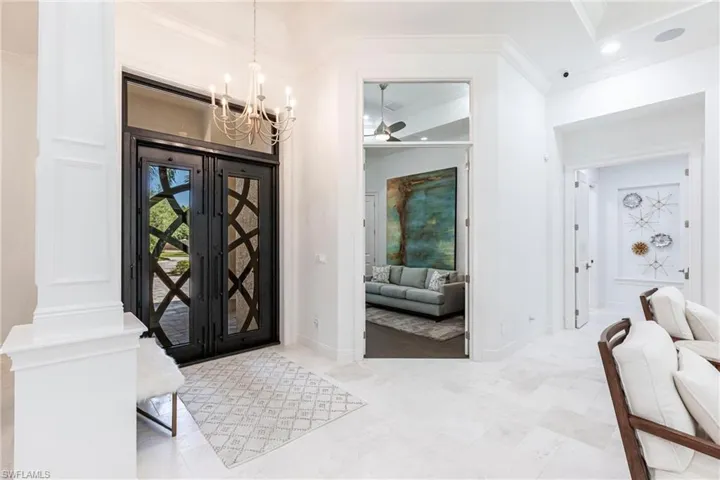 Foyer entrance featuring recessed lighting, ceiling fan with notable chandelier, baseboards, and ornamental molding