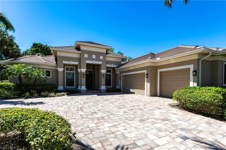 Prairie-style home with a tile roof, decorative driveway, a garage, and stucco siding