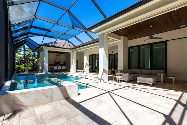 View of swimming pool featuring a patio area, a lanai, outdoor lounge area, and ceiling fan