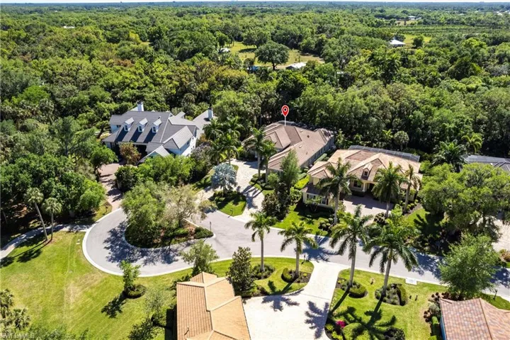 Drone / aerial view with a residential view and a wooded view