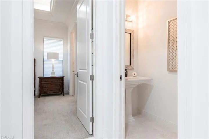Bathroom with baseboards and ornamental molding