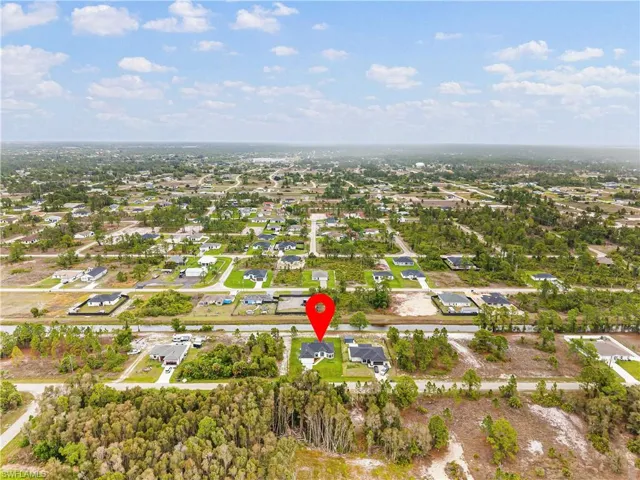 Aerial overview of property's location featuring nearby suburban area