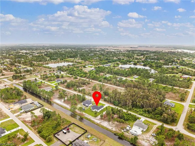 Aerial view of residential area featuring a nearby body of water