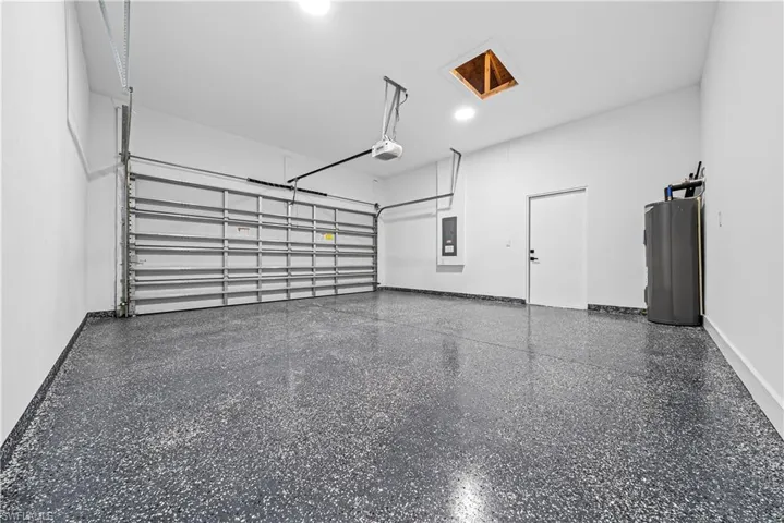Garage with electric water heater and baseboards