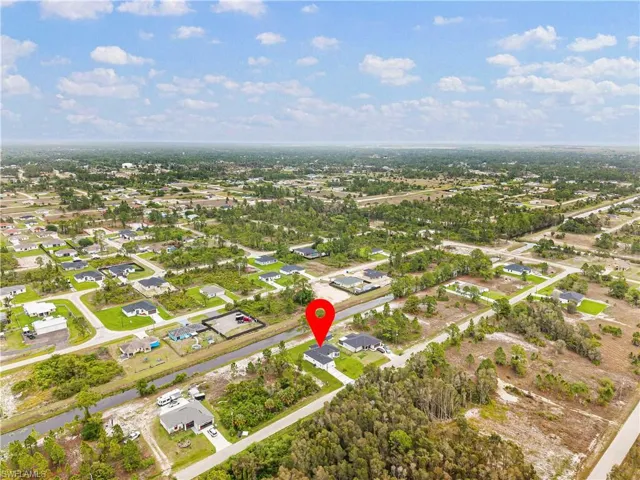 Aerial overview of property's location with nearby suburban area