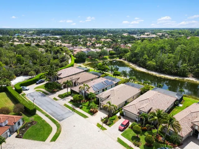 Drone / aerial view with a water view and a residential view