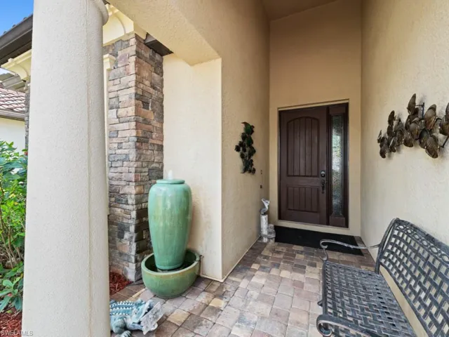 Entrance to property featuring stucco siding