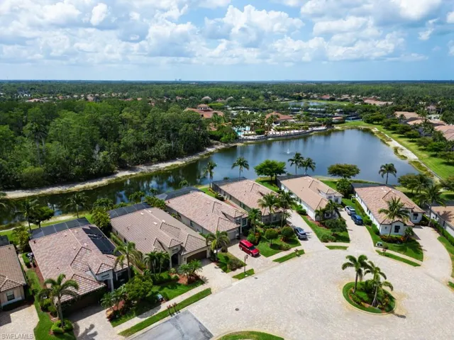 Drone / aerial view with a residential view and a water view