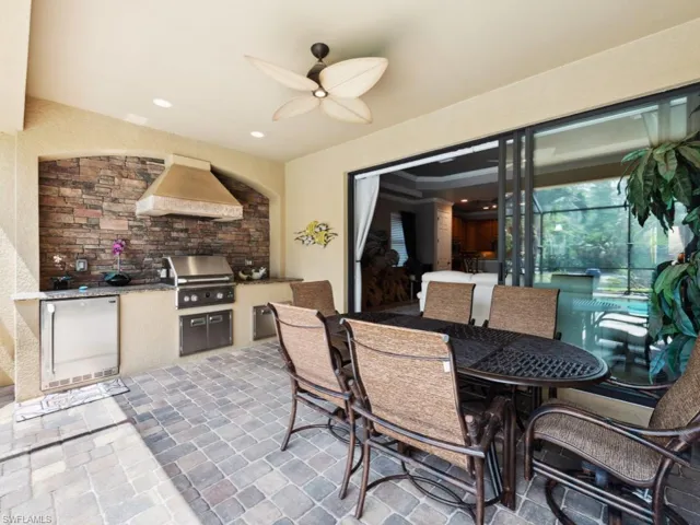 View of patio with an outdoor kitchen, ceiling fan, and area for grilling