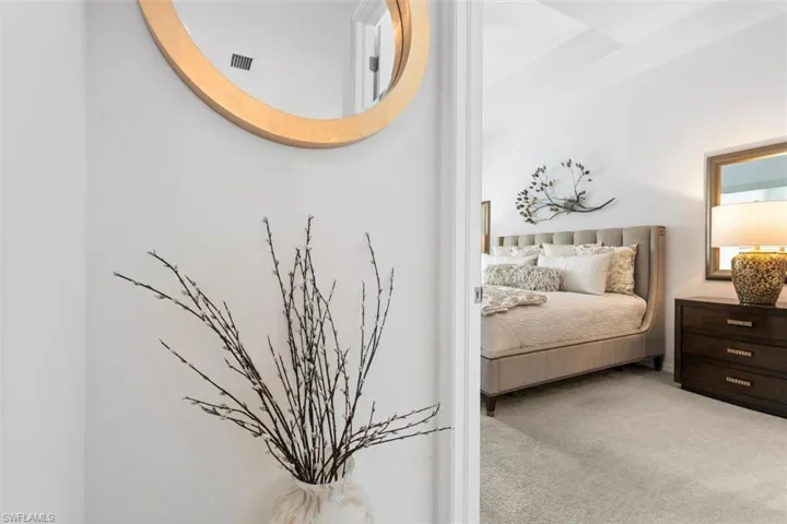 Bedroom featuring light colored carpet