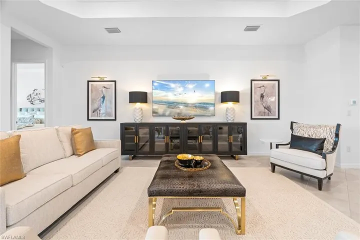 Tiled living room with a raised ceiling