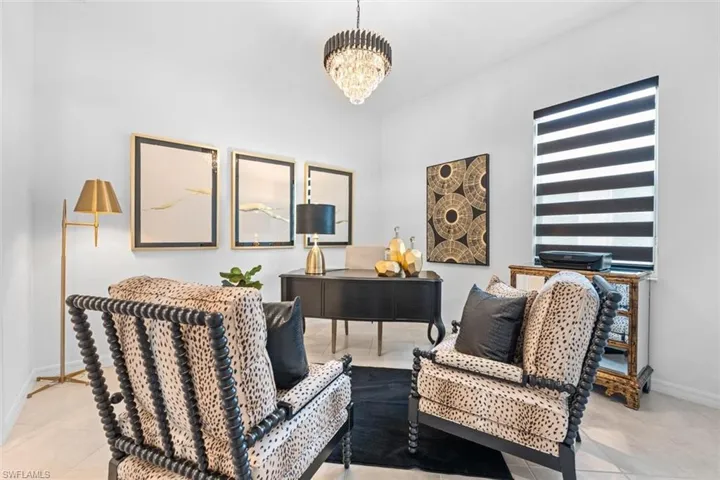 Living area with a chandelier and light tile flooring