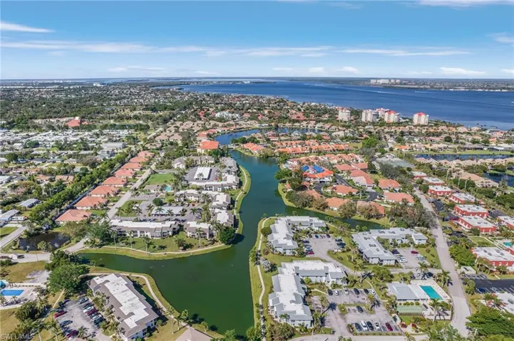 View of property location featuring a large body of water and nearby suburban area