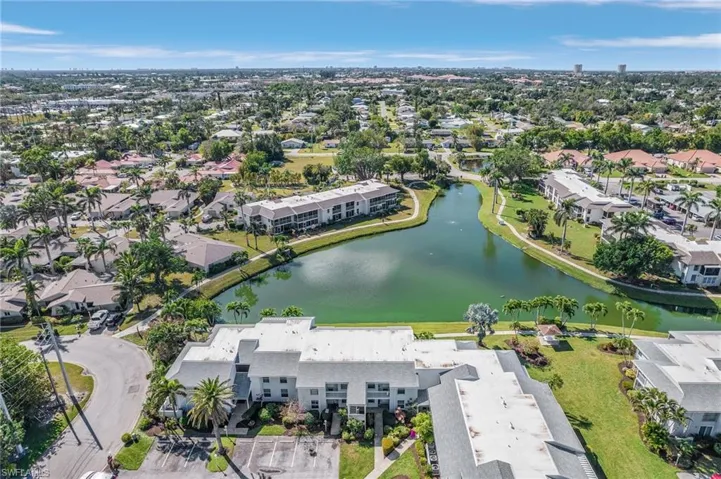 Aerial view of property and surrounding area with a nearby body of water