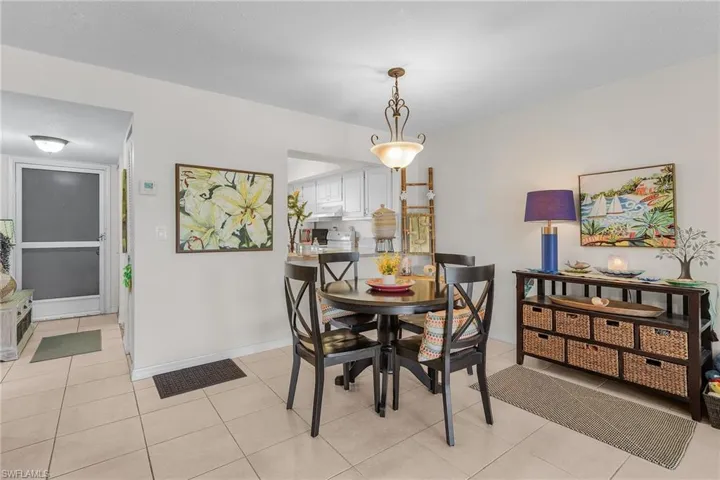 Dining space featuring light tile patterned floors and baseboards