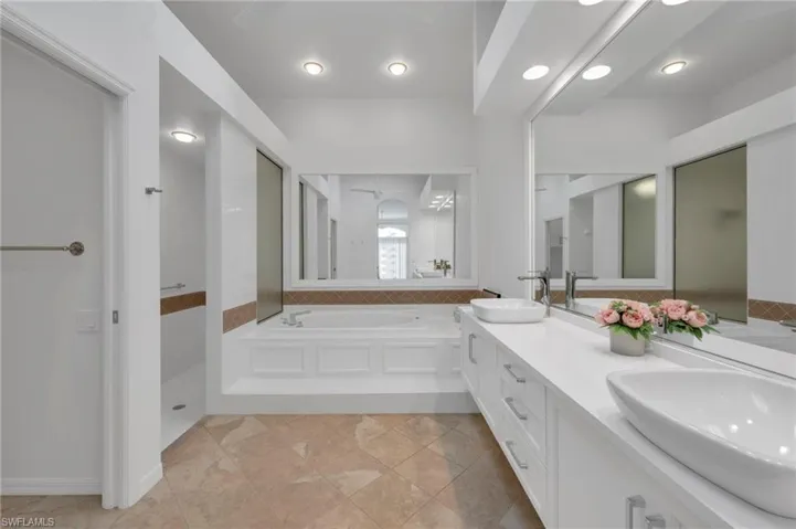 Primary Bathroom with dual sinks, seperate tub and shower