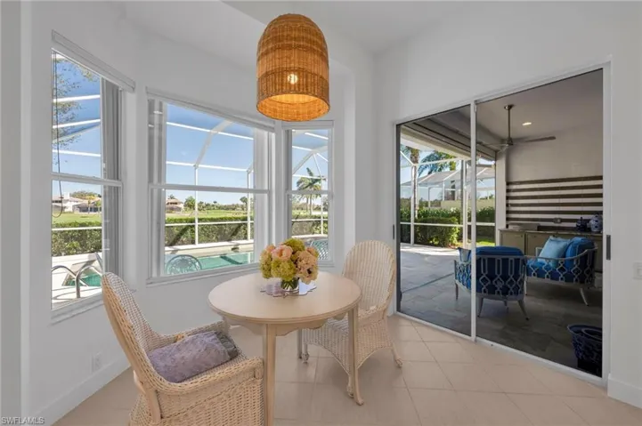 Eeat-in Kitchen with views to pool area, including outdoor kitchen and golf course.