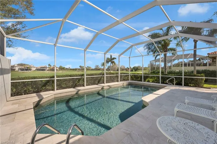 Refinished pool and tiled lanai, with golf course and lake views