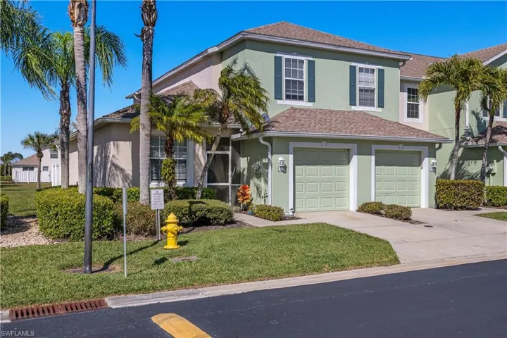 View of front of property featuring a front lawn and a garage