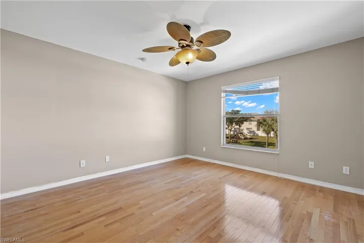 2nd floor bedroom 2with ceiling fan and light hardwood / wood-style floors