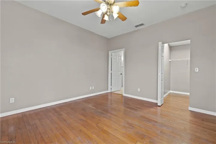 First floor bedroom with ceiling fan, a closet, and light hardwood / wood-style flooring