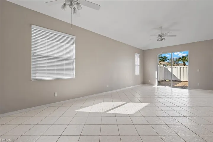Tiled living room featuring ceiling fan