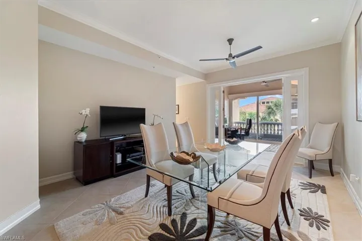Dining space with baseboards, crown molding, and light tile patterned flooring