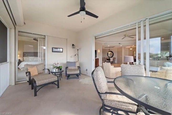 View of patio with a ceiling fan and outdoor dining area