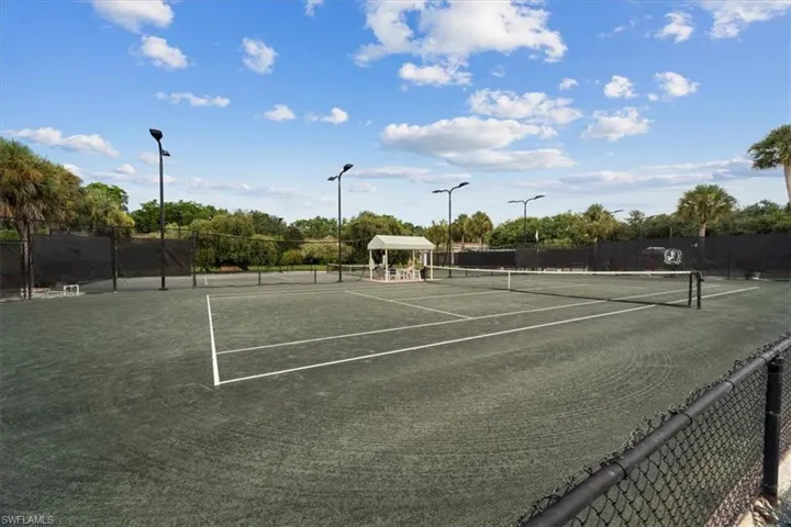 View of tennis court featuring a gazebo and community basketball court