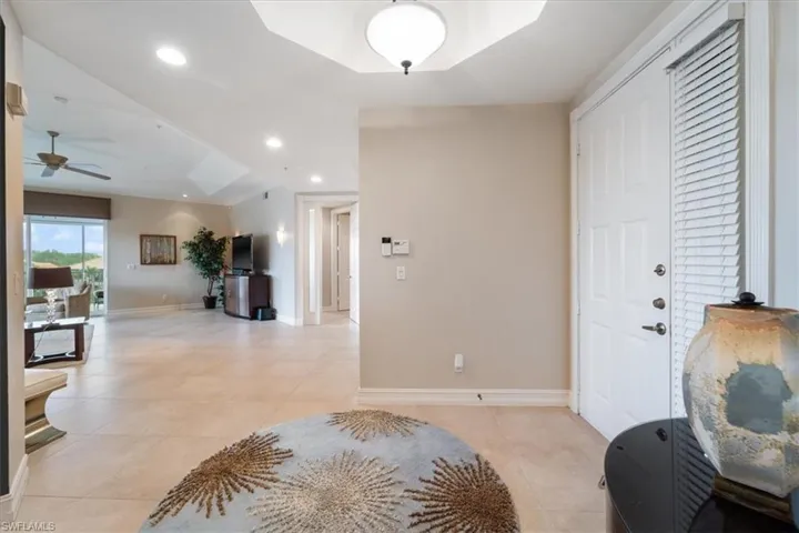 Foyer featuring recessed lighting, baseboards, a ceiling fan, and light tile patterned flooring
