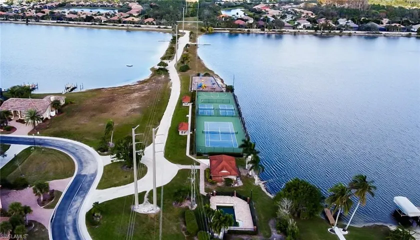 Waterfront community featuring multiple tennis courts, a swimming pool, and dedicated docks