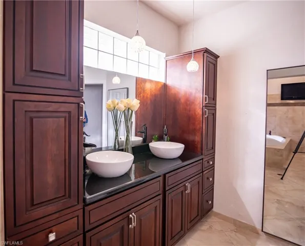 Dual vessel sinks with wall-mounted faucets