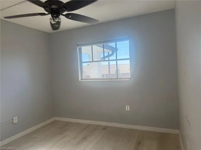 Empty room featuring ceiling fan and light wood-type flooring