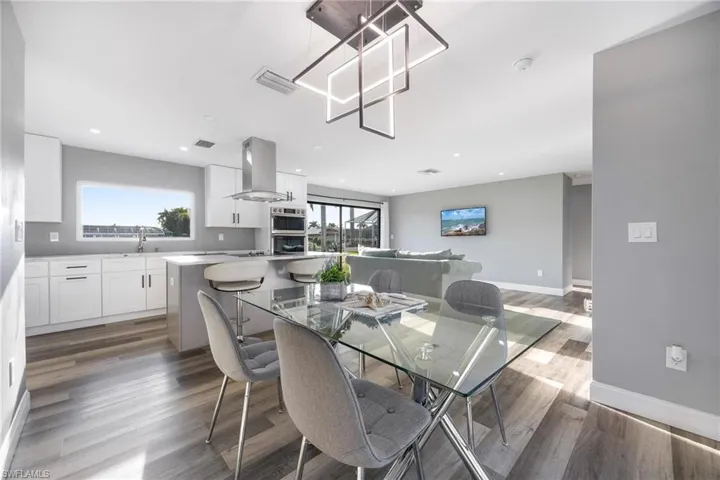 Dining room featuring recessed lighting, wood finished floors, visible vents, and baseboards